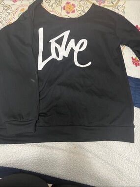 Black 'Love' Graphic Pullover Sweatshirt. Leggings with curve hugging also
